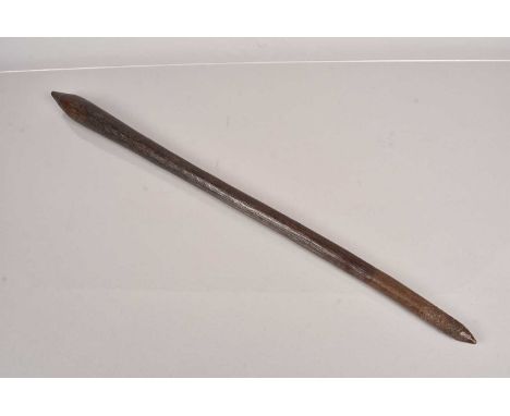 A Tribal Club, possibly Aboriginal, having long, thin shaft leading to the larger terminal, having incised line design, with 