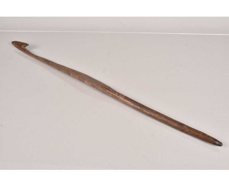 An Australian Aboriginal Spear Thrower, having carved markings to the majority of the body, with a shaped grip, 72.5cm