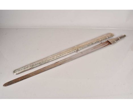 A late 19th Century/ early 20th Century Omani Kattara sword, having white metal handle, and scabbard, believe to be silver, h