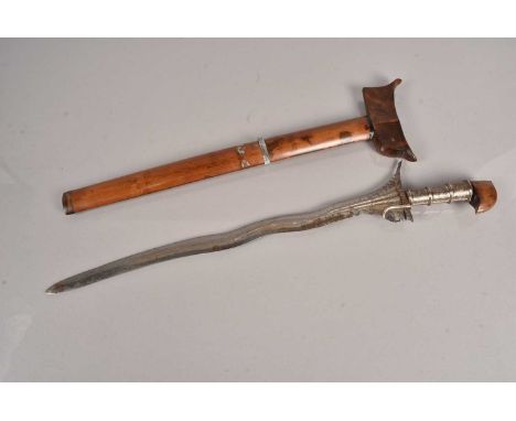 A Malayan Kris, having decorative metal grip, with stylised wooden pommel, with 49cm long fullered blade, with wooden scabbar