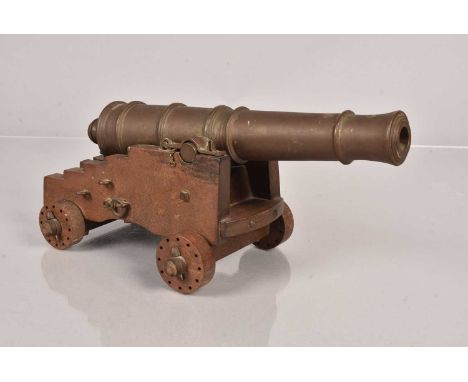 A model of a 32 Pounder Muzzle Loading Lower Deck Gun, by Model Gun Founders, Engs, Parkstone Dorset, having plaque to the un