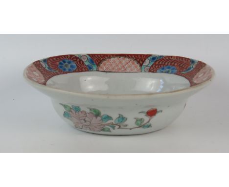 A Chinese porcelain oval bowl with polychrome enamel floral decoration, bears six character marks to the base, 22cm wide. 