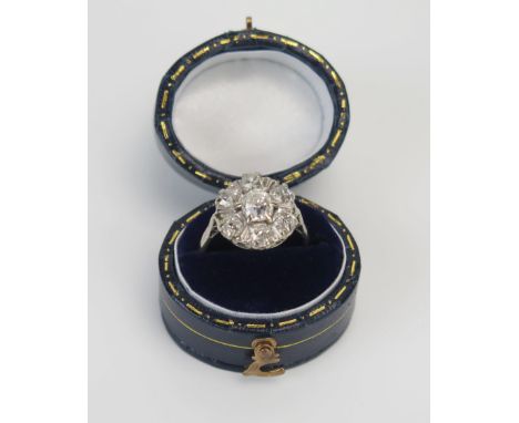 An Early 20th Century Old Cut Diamond Cluster Ring in a precious white metal setting, 13.5mm head, c. 6.3x4.7mm central stone