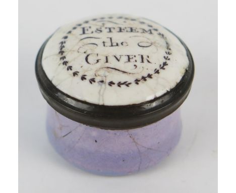 A 19th century enamel patch box of circular outline, the pull-off top inscribed "Esteem the Giver", 2cm diameter. 