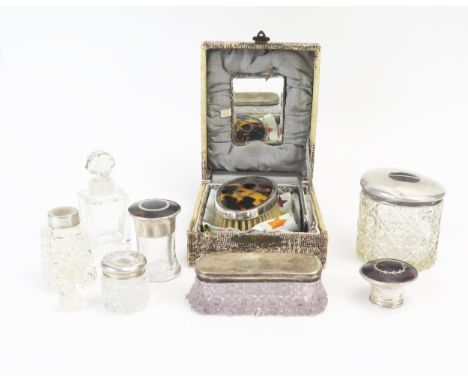 A collection of assorted clear glass and silver mounted dressing table jars and bottles, a silver and tortoiseshell mounted b