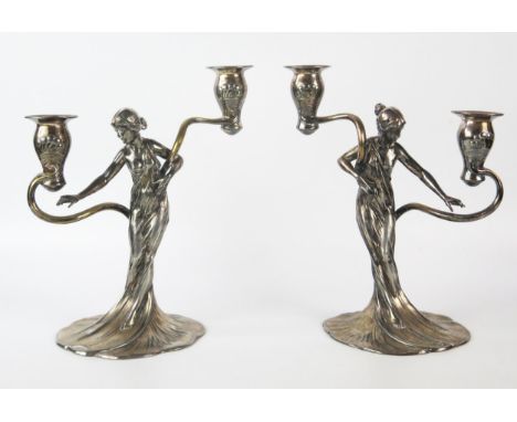 WMF, a pair of Jugendstil silver plated figural twin branch candelabra, the sconces on sinuous swept branches supported by se