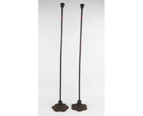 A pair of 19th century cast iron and steel wool bobbin holders, the steel shafts with turned wood pommels, mounted on cast ir