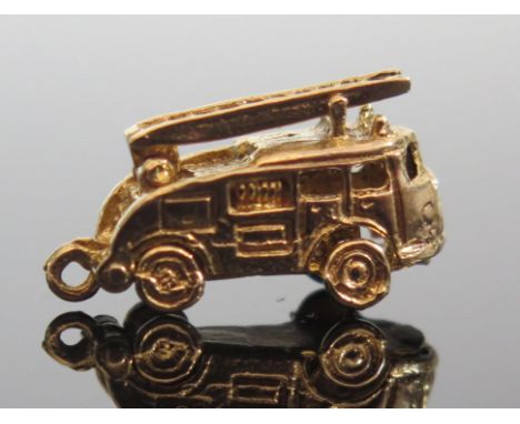 A 9ct Gold Fire Engine Charm with articulated ladder and hinged body lifting off to reveal interior, maker G&amp;H, 4.3g 
