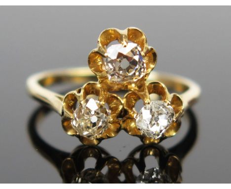 An Old Cut Diamond Three Stone Ring in an unmarked high carat gold setting, size M.25, 3.2g 