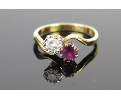 An 18ct Gold, Ruby and Diamond Crossover Ring, ruby c. 4.2mm diam. and diamond c. 4mm, size K, 3.1g 