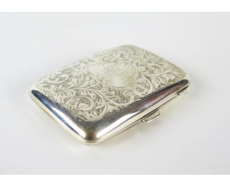 A George V silver cigarette case, maker W H Haseler Ltd, Birmingham 1924, monogrammed, with chased foliate and scroll decorat