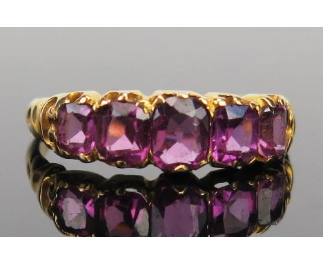 An Antique 'Amethyst' Paste Ring in an unmarked high carat gold setting, size M.25, 2.6g 