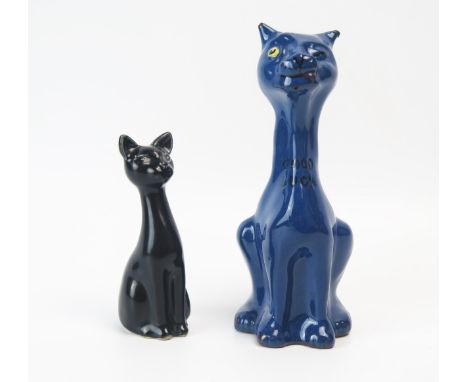 A Torquay pottery model of a winking cat, incised "Good Luck", to a blue ground, 16.5cm high, together with a small black pot