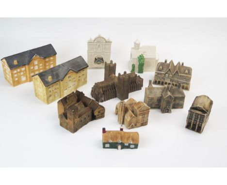 A collection of crested and pottery model buildings, including Exeter Guildhall, Exeter Cathedral, Warfleet Pottery works, Mo