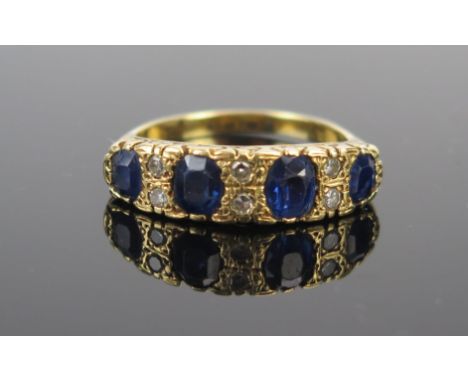 An 18ct Gold, Sapphire and Diamond Ring, 6mm wide head, largest stones c. 5x4.5mm, size P.75, 7.2g 