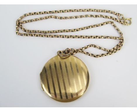 An Antique 9ct Gold Locket with engine turned decoration (Birmingham 1919, maker D&amp;F), 34mm diam. and on a 17.5" 9ct gold