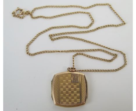 A 9ct Gold Locket with engine turned decoration and engraved with the initials OL and on a yellow metal chain, 2.5g locket. 