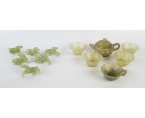 A collection of jade cups, teapot and six horses. 