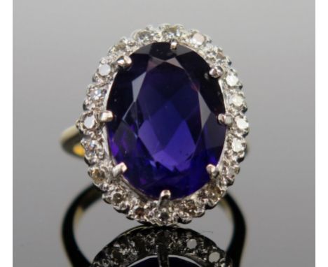 An 18ct Gold, Amethyst and Diamond Cluster Ring, 16x12mm central stone surrounded by c. 2mm diamonds, c. 21x16.5mm head, size