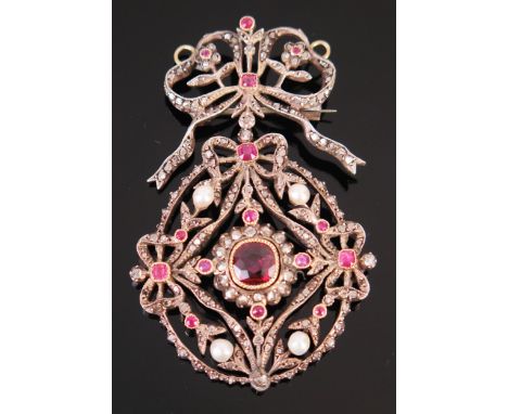 A Ruby, untested Pearl and Rose Cut Diamond Pendant with ribbon swag and foliate decoration and in a white metal setting, wit