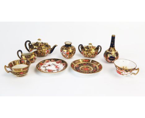 A small collection of Royal Crown Derby miniature teawares, includes teapot, sucriere, cream jug, cups and saucers 