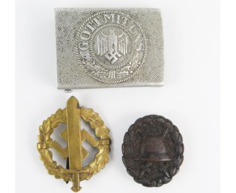 A Third Reich period Wounds Badge (black), an SA sports  and an army belt buckle. (3). 