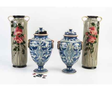 A pair of Hart &amp; Moist, Exeter, pottery vases and covers of ovoid form with moulded ring handles to the side, on a spread