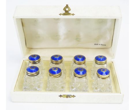 A set of eight silver gilt and enamel mounted clear glass condiments, maker Hroar Prydz, Oslo, stamped marks, contained in a 