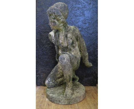 A 19th century carved model figure of a kneeling street urchin, weasring rolled trousers, open shirt and hat, one arm missing