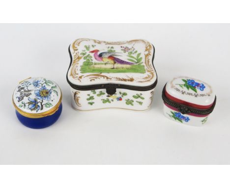 A porcelain and gilt metal mounted box of cartouche outline , the hinged lid decorated with a golden pheasant, with floral de