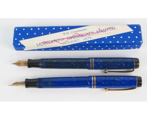 A Parker Duofold fountain pen, together with another example in variegated blue colours. 