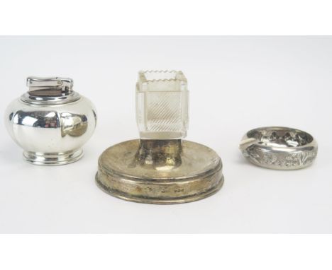 A clear glass and silver mounted ashtray and vesta holder, a Sterling silver ashtray and a hallmarked silver table lighter. (