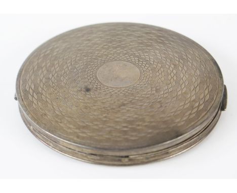 A George VI silver powder compact, maker R Davis &amp; Co, Birmingham 1946, with engine turned decoration, 8.5cm diameter. 
