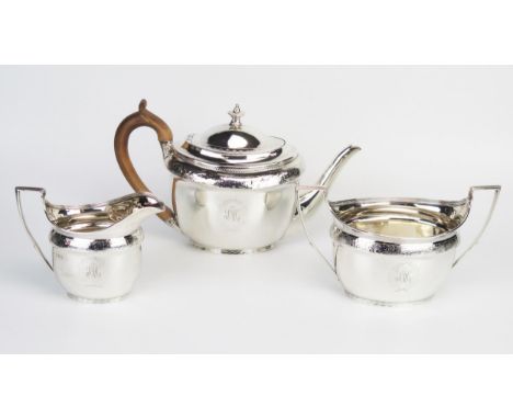 A George III silver three piece tea service, maker John Emes, London, 1800/01, initialled, of oval outline, with banded folia