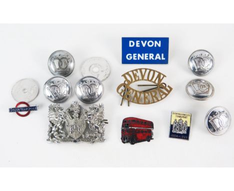 A Devon General brass cap badge, buttons, enamel bus badge and other items. 