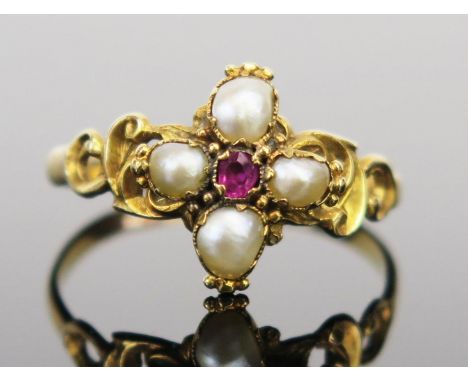 An Antique Ruby and untested Pearl Ring in an unmarked high carat setting with pierced scrolling shoulders, 12.5mm head, size
