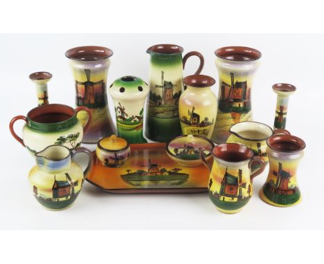 A collection of Watcombe pottery vases, jugs, dressing table wares, hat pin holder, candlesticks etc all with windmill design