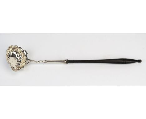 A Georgian silver toddy ladle, maker William Coles, remaining marks worn, with lobed oval bowl mounted on an ebonised and rin