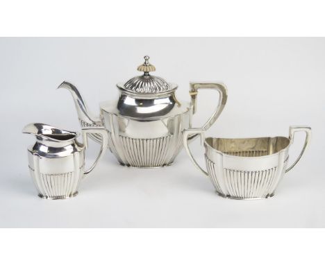 An Austro-Hungarian three-piece tea service, stamped marks, of oval outline, with half reeded decoration, total weight of sil
