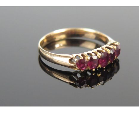 A Ruby Five Stone Ring in an unmarked high carat gold setting, largest stone c. 4x3.2mm, size L, 2.3g. 