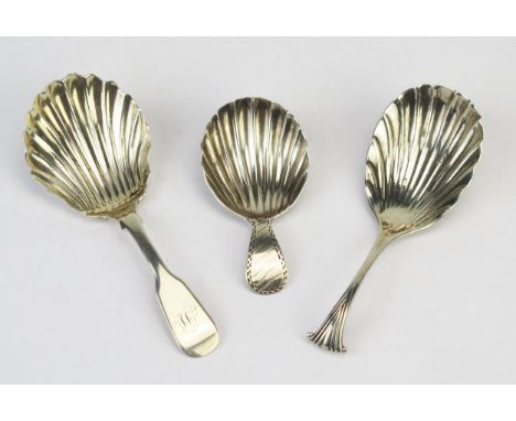 Three silver shell-shaped caddy spoons, maker William Hutton &amp; Sons, London, 1889, James Ross, Glasgow, 1842 and an unkno