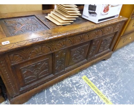 AN ANTIQUE CARVED OAK PANEL COFFER. 