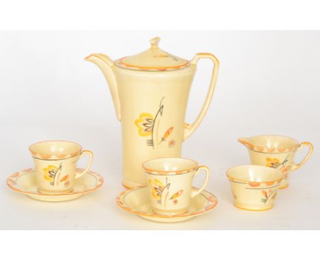 A 1930s Crown Devon coffee set comprising coffee pot, four cans and saucers, milk jug and sugar bowl, all decorated with styl