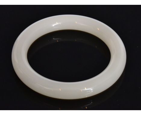 A Chinese white jade bangle of even translucent colour, outer diameter 8cm, inner diameter 5.7cm 