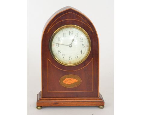 An Edwardian mahogany cased mantel clock with a white enamel dial within a Gothic arch case detail with boxwood stringing and