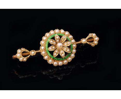 A Victorian hallmarked 15ct seed pearl and enamel pin brooch, the central pearl set flower head within green enamelled circul