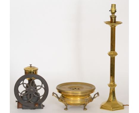 A 20th Century Spanish spice grinder with spoked wheel, a brass two handled circular heater and a single brass alter candlest