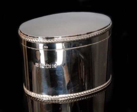 A modern hallmarked silver oval tea caddy of plain form with gadroon borders to base and hinged cover, height 9.5cm, Birmingh