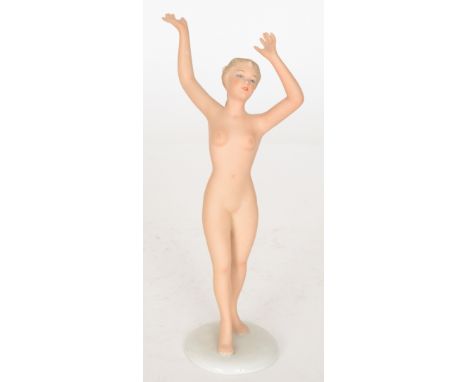 A Goebel figure of a nude lady with her arms outstretched, impressed marks with foil sticker to the base, height 25cm