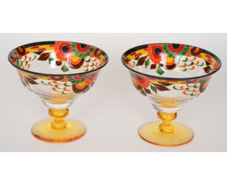 A pair of 1930s Stuart & Sons pedestal dishes with an amber glass foot below a clear crystal glass bowl enamel decorated with